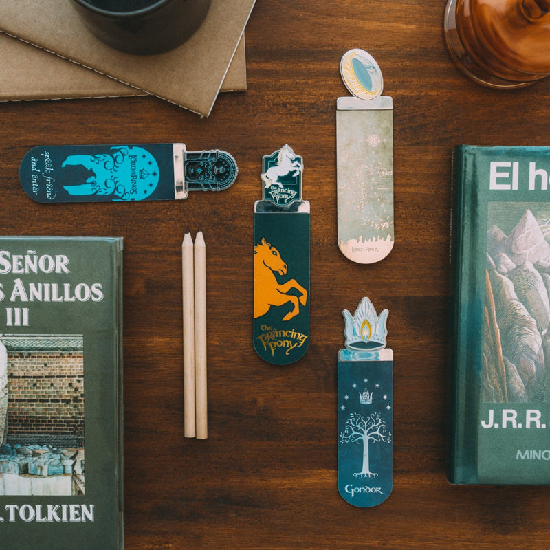 lord of the rings set of 4 bookmarks on a wooden table with stationery and books