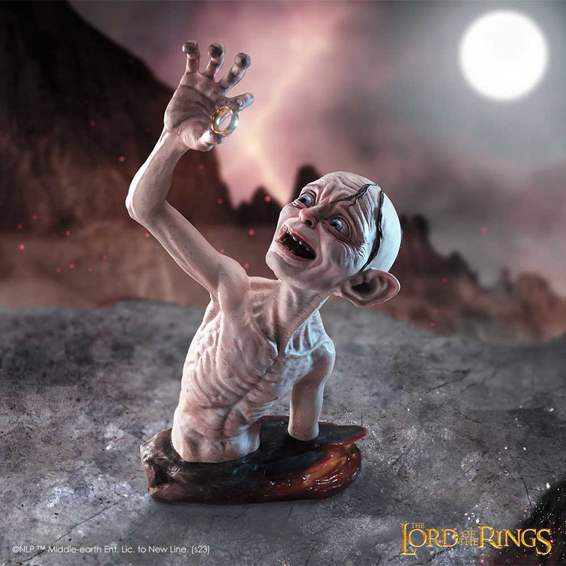 Gollum figurine from 'The Lord of the Rings' with a dark, mountainous background.
