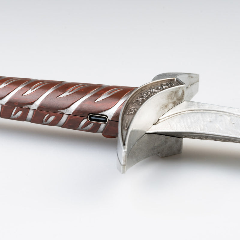 Close-up of a silver knife with a brown handle on a white background