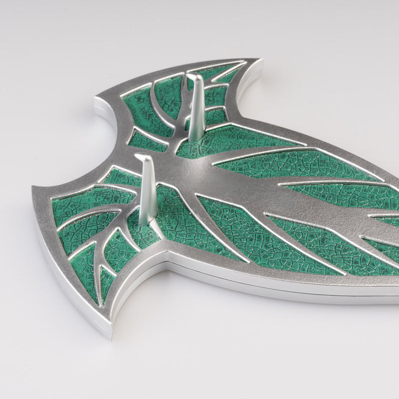Metallic wall plaque with green and silver design on a white background