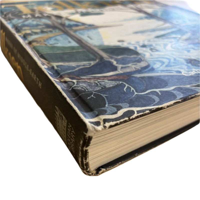 corner of maker of middle earth showing moderate wear and scuffing to the edges of the cover and spine