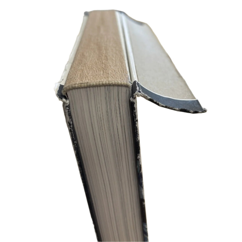 maker of middle earth spine with the cover lifted away so the place where it has detached can clearly be seen. There is scuffing to the surrounding edges of the covers