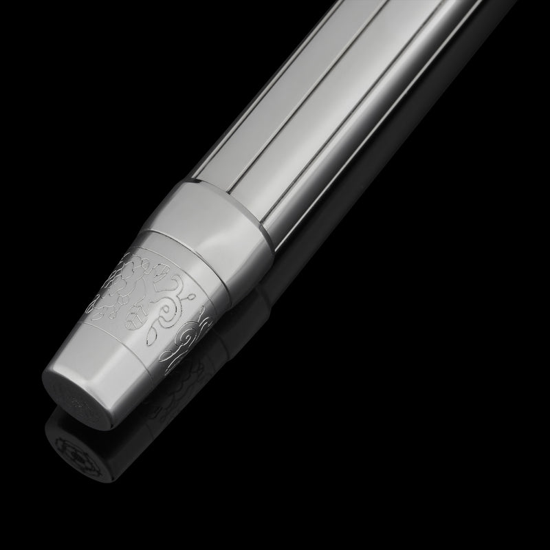 Silver pen with intricate design on a black background