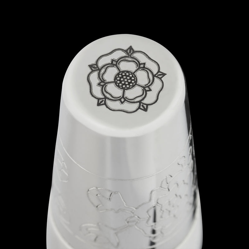 bottom of fountain pen featuring engraving of a tudor rose on a black background