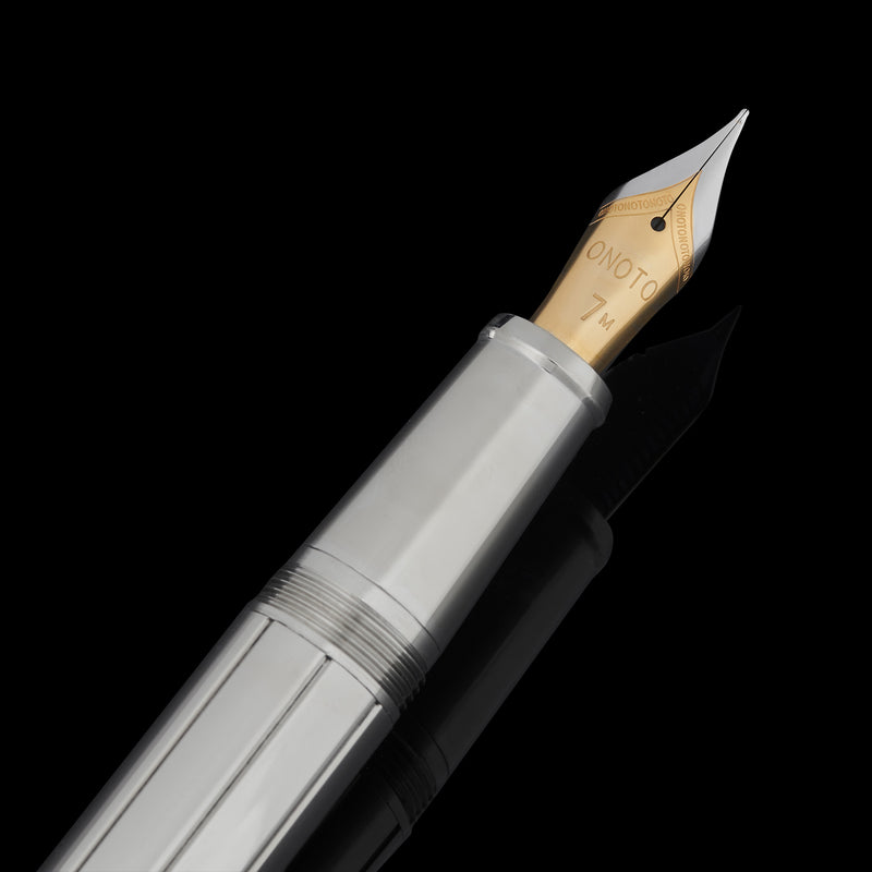 close up of fountain pen nib on black background