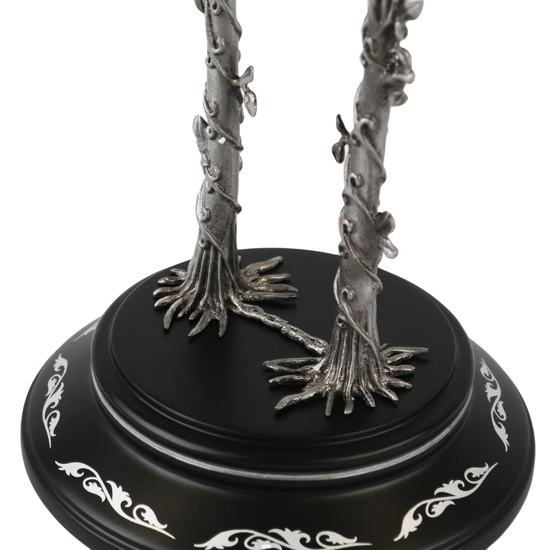 Decorative item with silver tree-like branches on a black base with white patterns