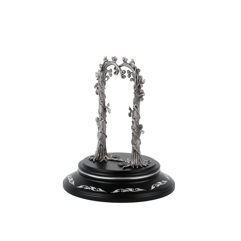 Decorative metal arch on a black base with white patterns against a white background