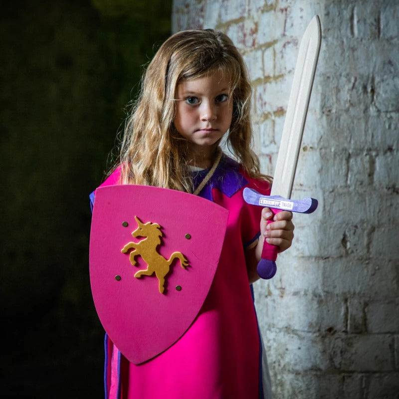  child holding the Childrens Medieval shield in pink with gold unicorn emblem 