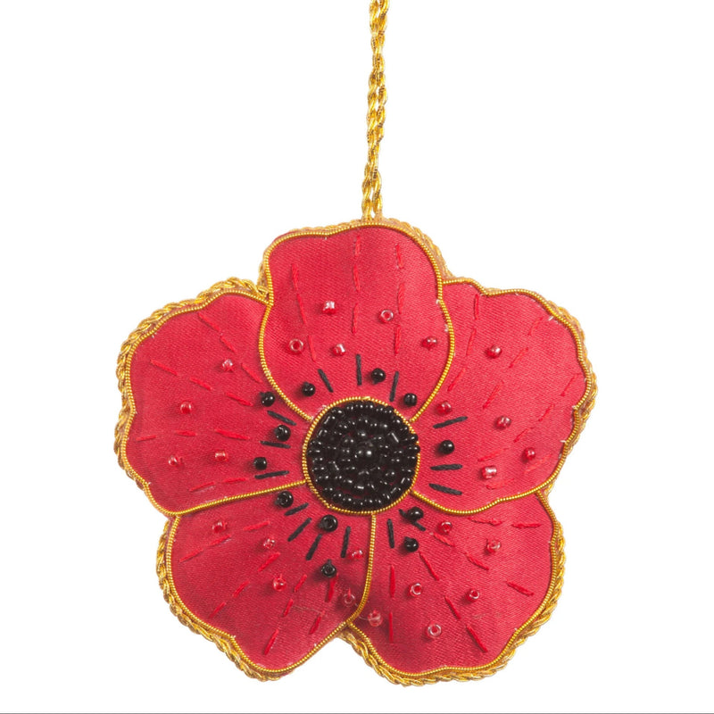 Red poppy flower ornament with gold trim on a white background