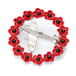 Silver coloured spitfire in a red poppy ring brooch