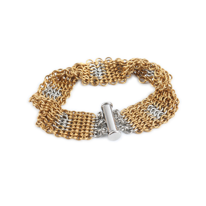 Gold and silver chainmaille bracelet on a white background