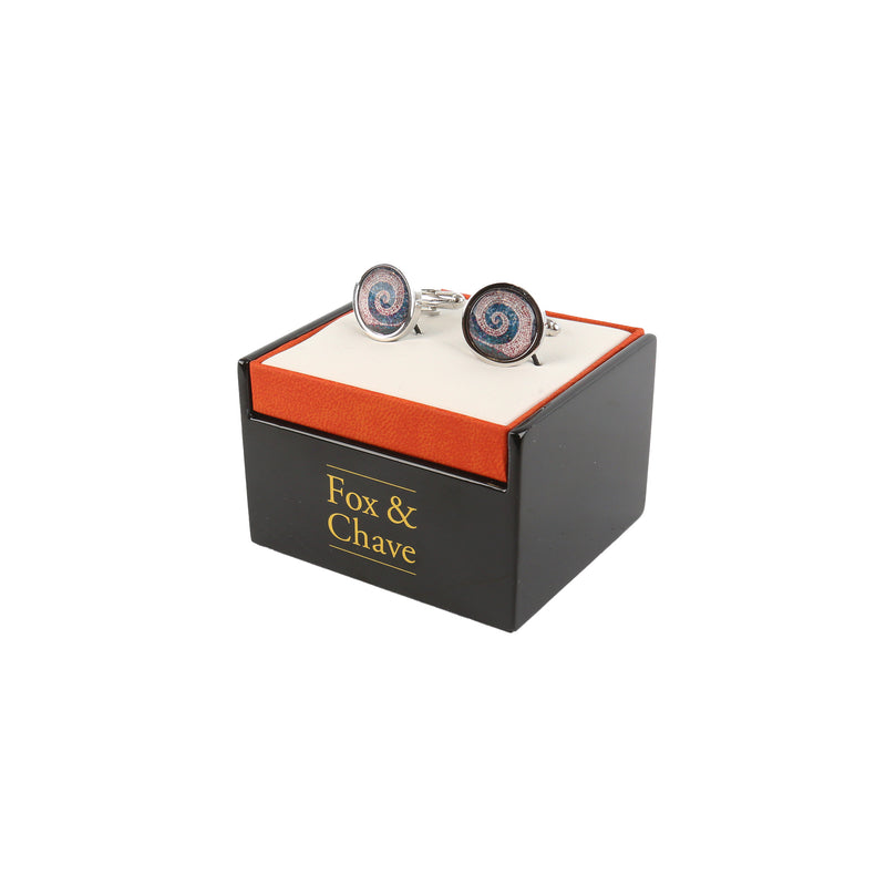 left side view of roman mosaic spiral cufflinks in black and orange branded presentation box