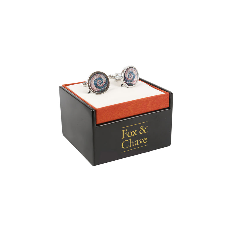 right side view of roman mosaic spiral cufflinks in black and orange branded presentation box