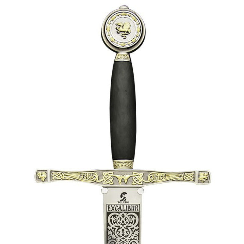 Decorative sword with black handle and gold accents supported by mount on a white background