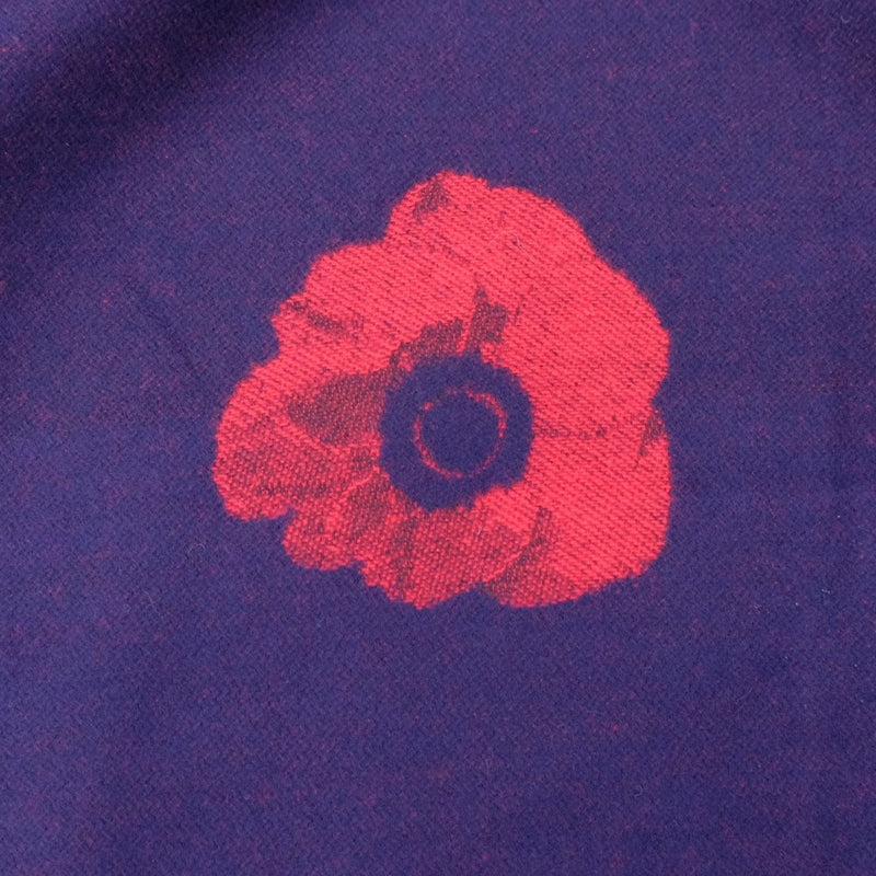 Red flower design on a purple fabric background