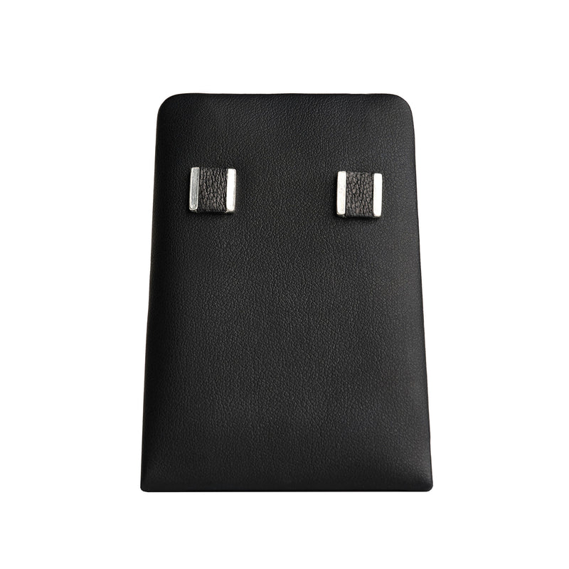 square stud with a black leather inlay on black display stand