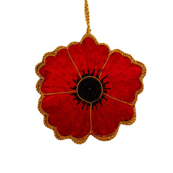 Red poppy flower ornament with gold detailing on a white background