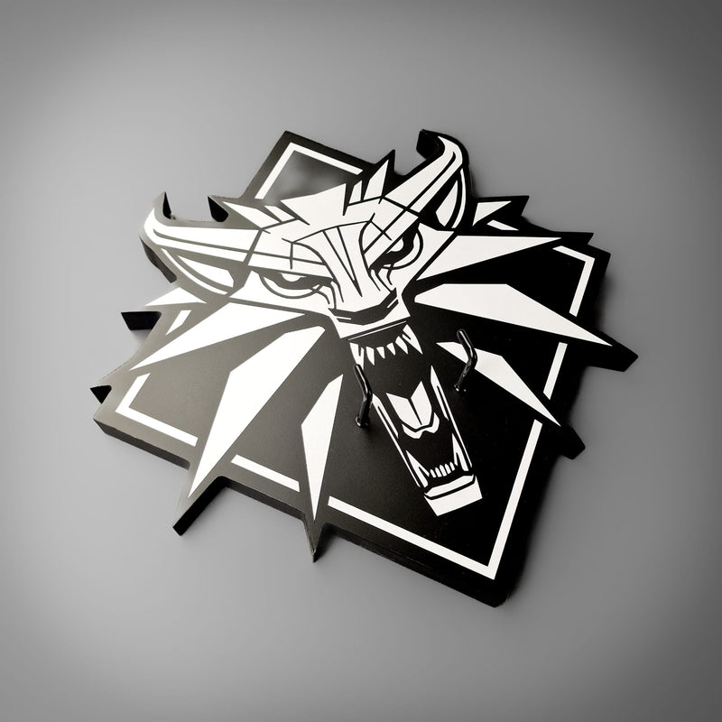 Black and white dragon head design on a gray background