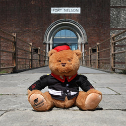 Fort nelson bear in victorian uniform on the bridge to the fort entrance