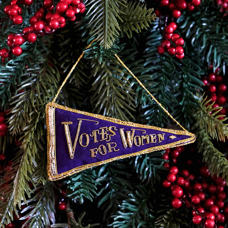 Votes for women hanging decoration on a christmas tree